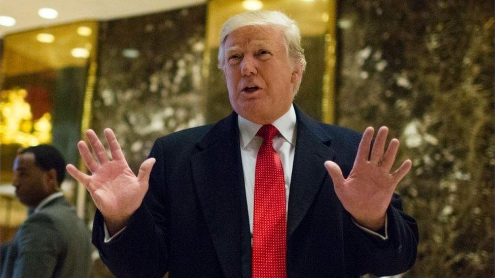 US President-elect Donald Trump stops to talk to the media in the lobby of Trump Tower.