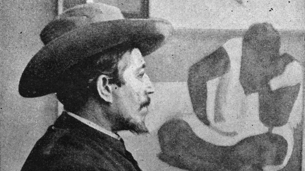 Gauguin pictured with one of his paintings in 1895