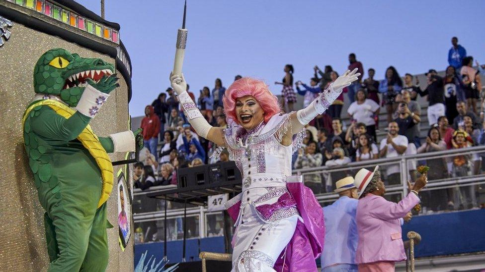 A person dressed as a crocodile and another as a nurse holding a big syringe