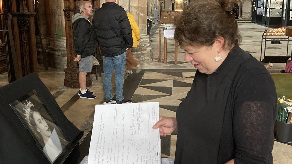 Rev Wendy Wale leafing through the book of condolence