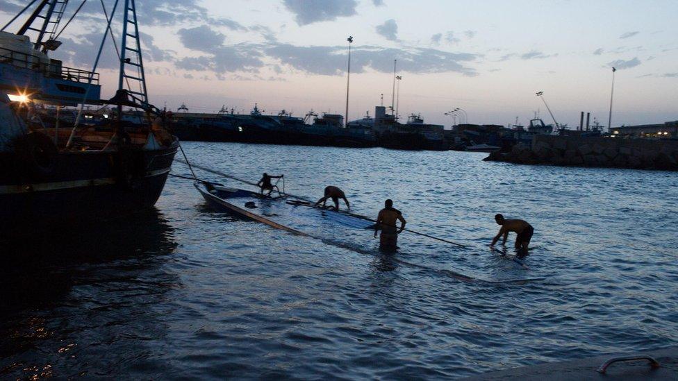 Wrecked boat which was carrying migrants is pulled into Zuwara port, Libya (27 August)