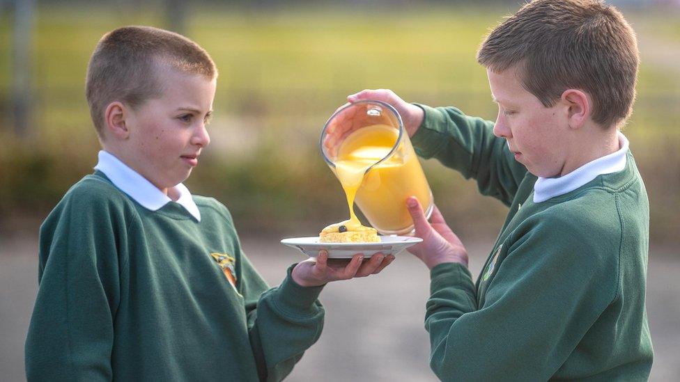 Schoolboys with dessert