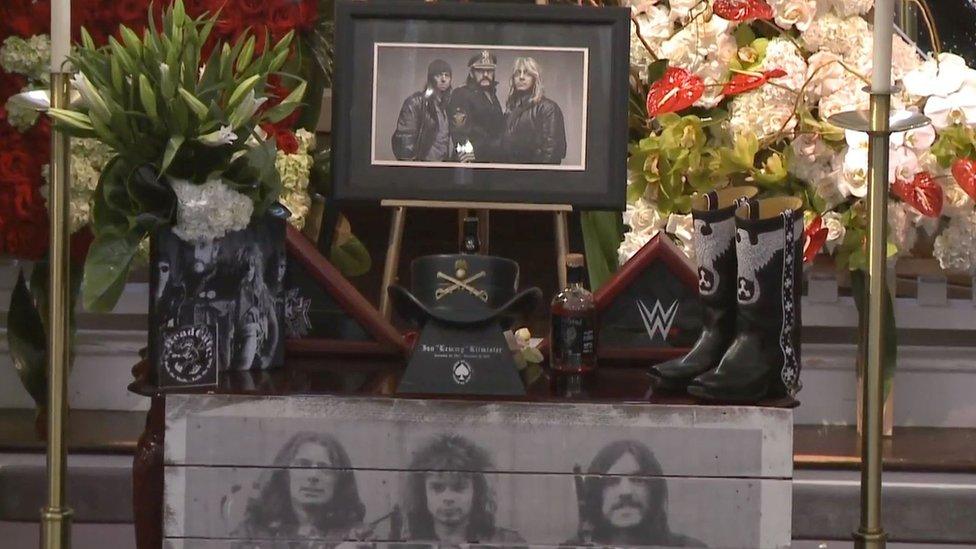 Photograph of Motorhead and flowers on display at funeral of Lemmy on 9 January 2016