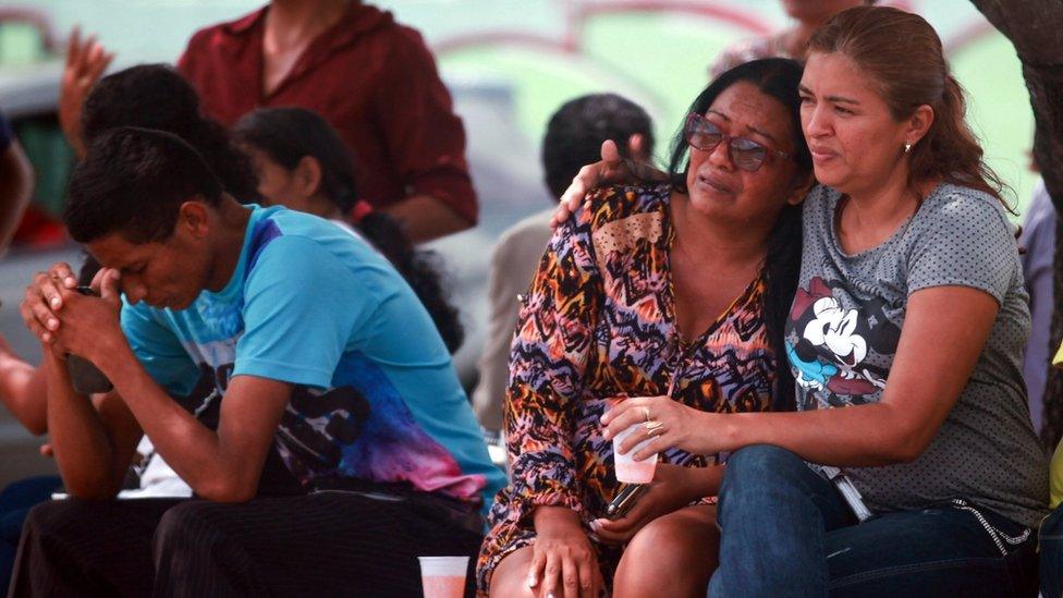 Relatives of inmates ask for information at the main gate of the Anisio Jobim Penitentiary Complex after a riot left at least 60 people killed and several injured, in Manaus