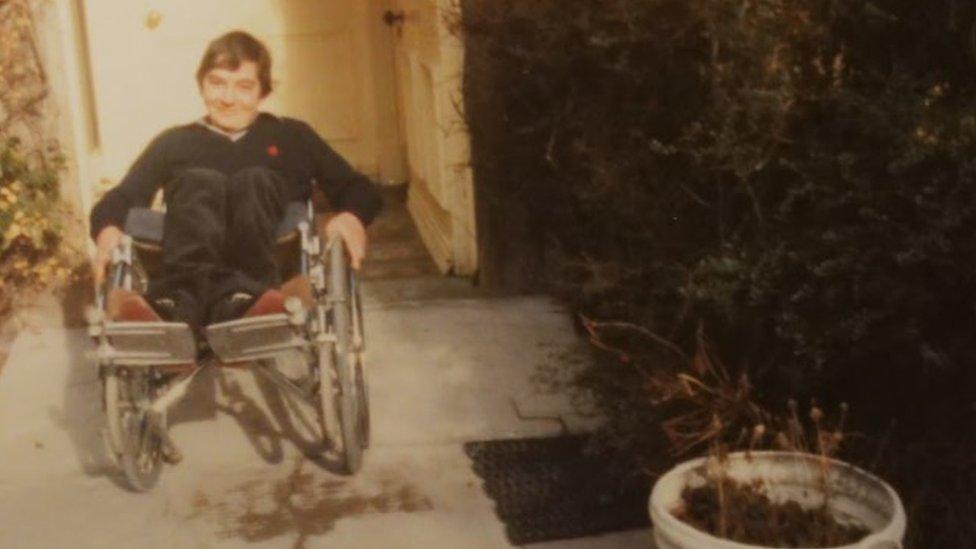 Andrew in his wheelchair as a teenager in the 1980s