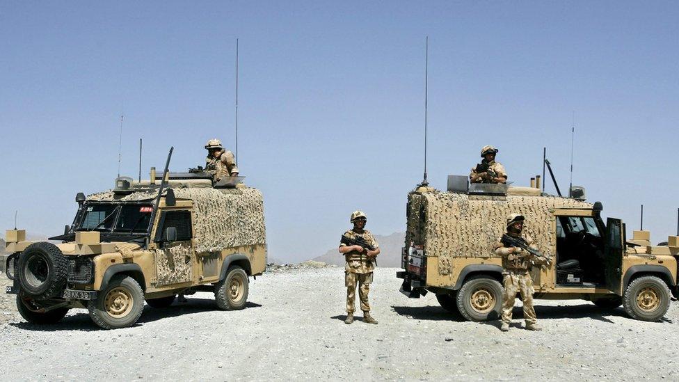 British soldiers blocking the road with two Snatch Land Rover vehicles in Afghanistan