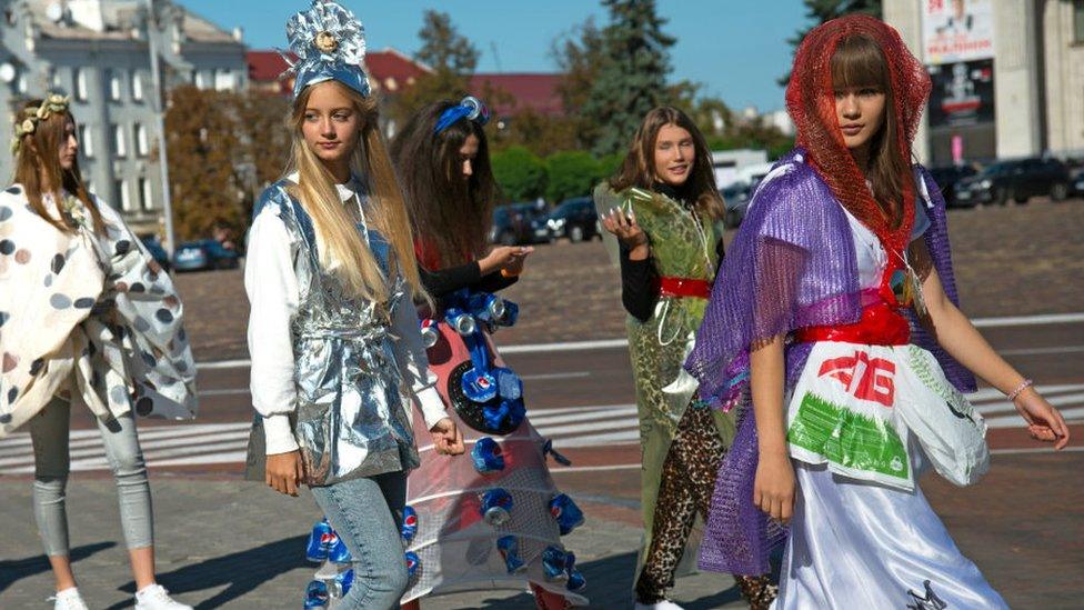 Participants of a fashion show wear outfits made out of garbage for World Cleanup Day in Chernihiv, northern Ukraine