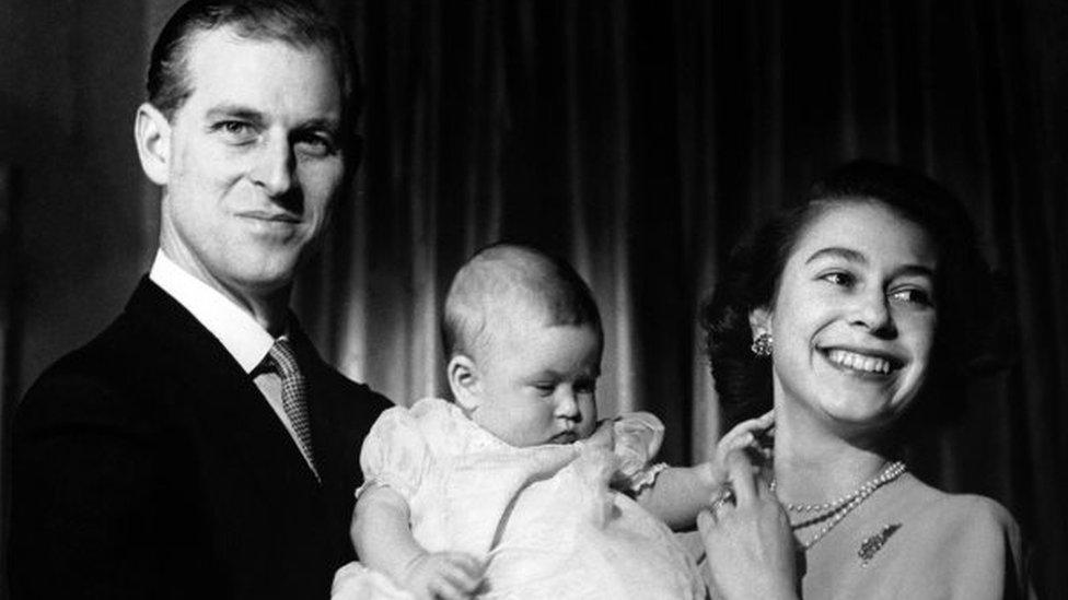 The Queen and the Duke of Edinburgh holding six-month-old Prince Charles