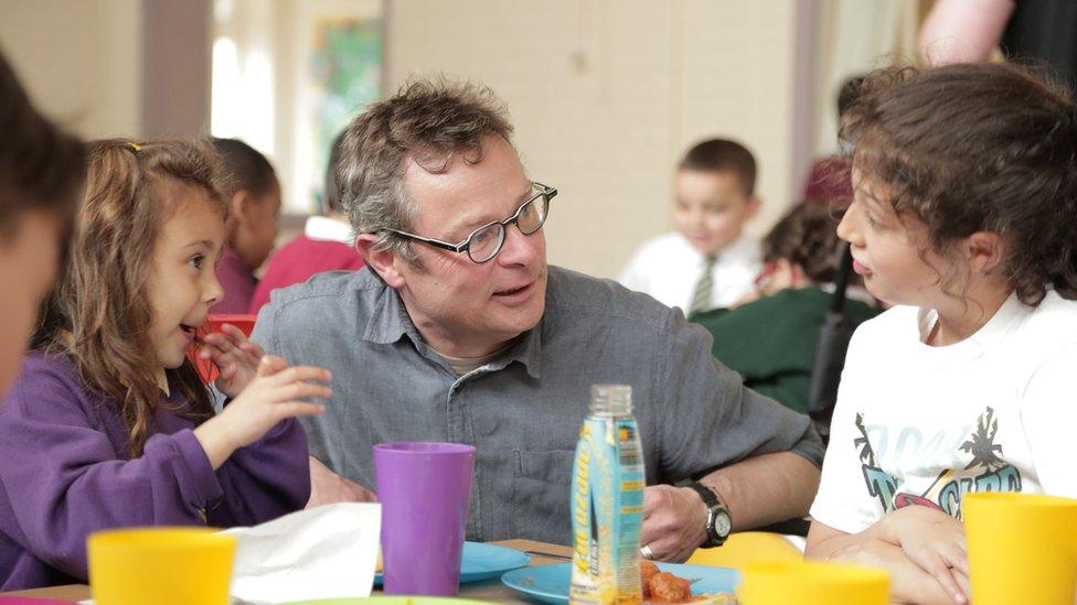 Hugh with two children from the Unity Youth Centre