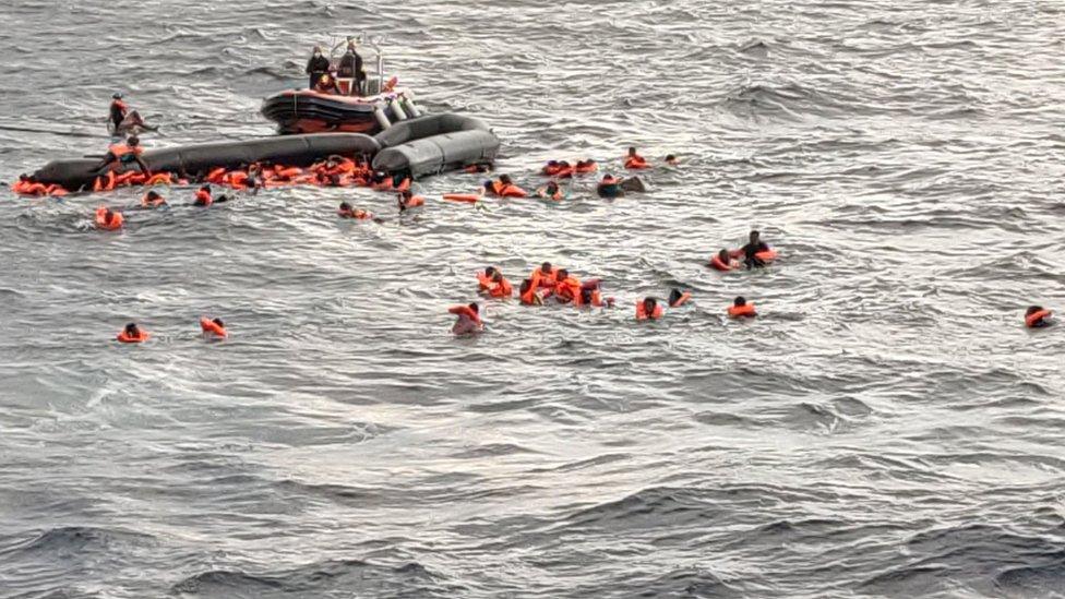 Image shows the capsized dinghy