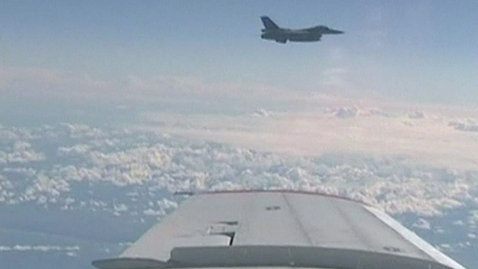 Screengrab purportedly showing a Nato fighter jet (background) close to a Russian plane carrying the defence minister