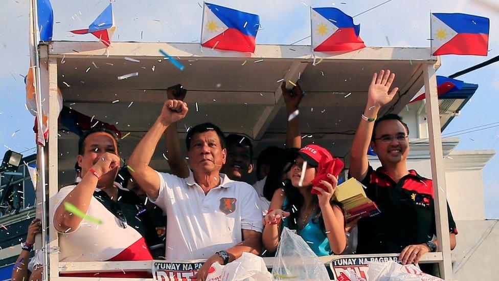 Mr Duterte raising his fist to supporters at at rally in Cainta Rizal on 12 April