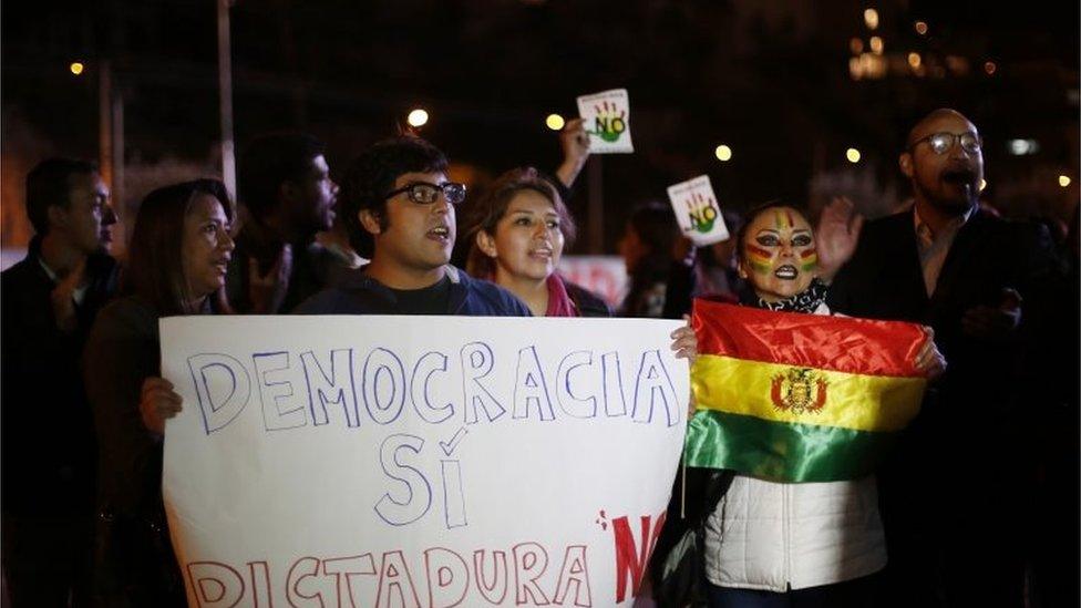 Demonstrators shout slogans against Bolivian President Evo Morales, demanding he concede, while waiting for the official results of a constitutional referendum outside a vote counting centre in La Paz on 23 February, 2016