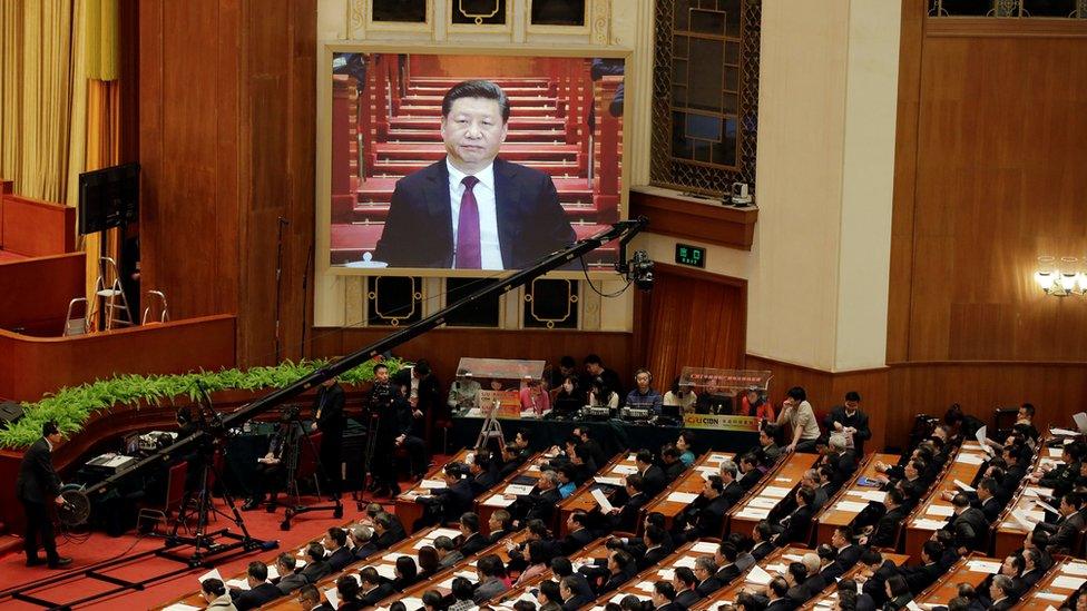 China's President Xi Jinping seen on a screen as he attends the opening session of the Chinese People's Political Consultative Conference (CPPCC) at the Great Hall of the People in Beijing, China, 3 March 2017