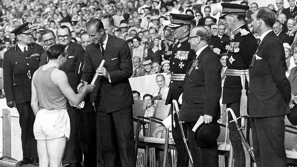 Former Wales rugby international and Olympian Ken Jones presenting the baton to the Duke of Edinburgh at the opening ceremony at Cardiff Arms Park