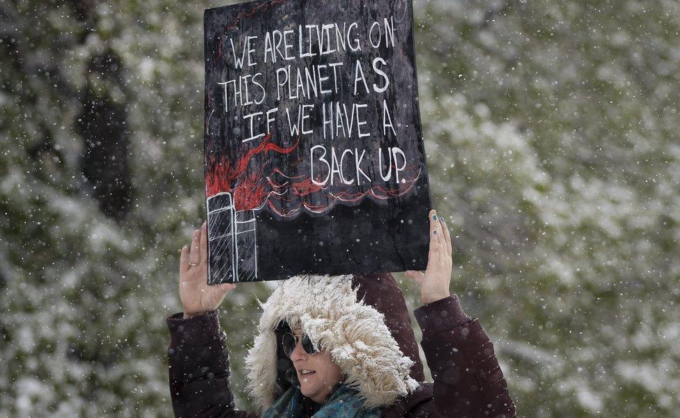 Leah Stein of Parker, Colorado holds a sign while protesting at the People's Climate March on Denver on April 29, 2017 in Denver, Colorado