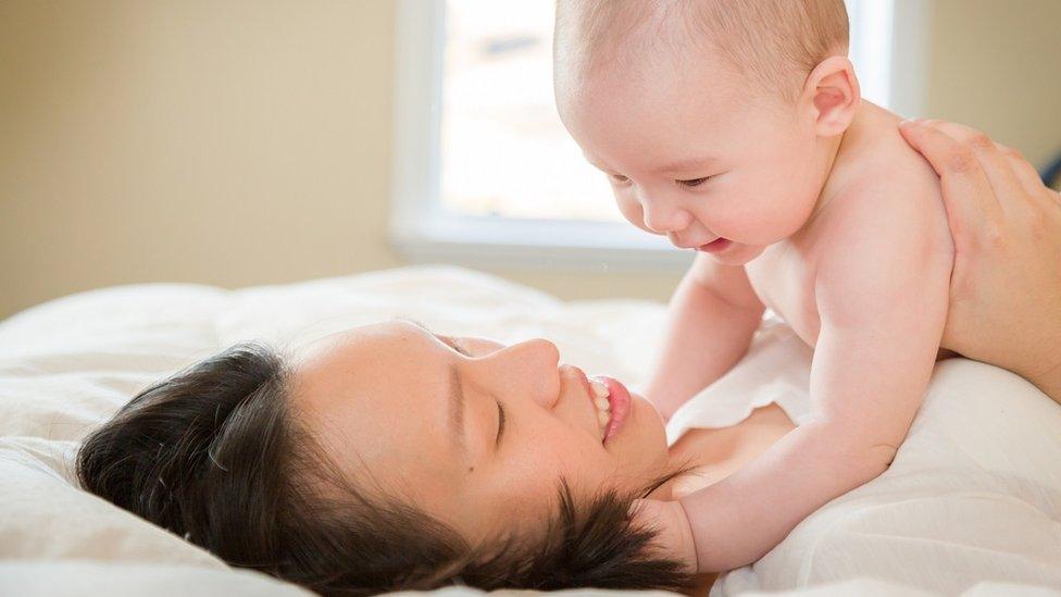 Stock image of woman with bab