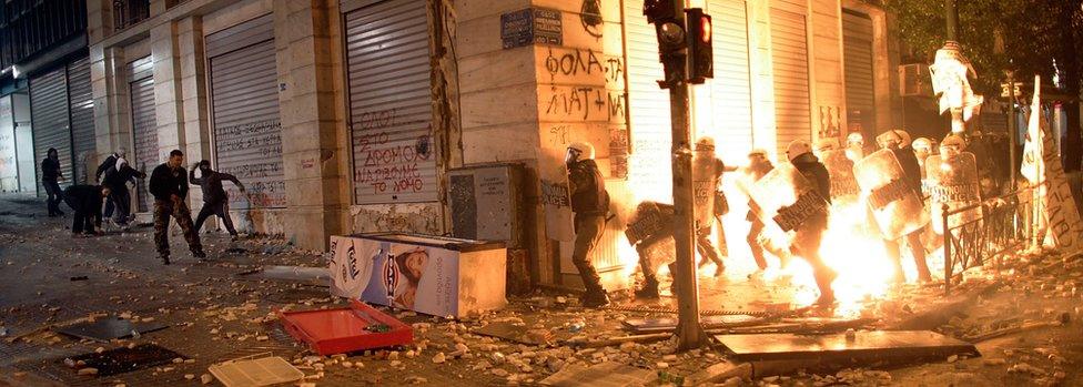 Demonstrators throw fire bombs to riot police during violent protests in central Athens February 12, 2012.