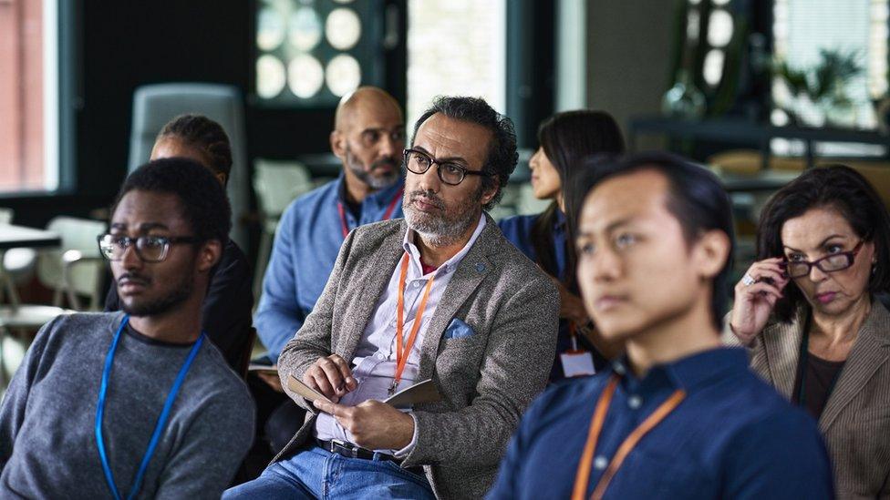 Businessman making notes at conference