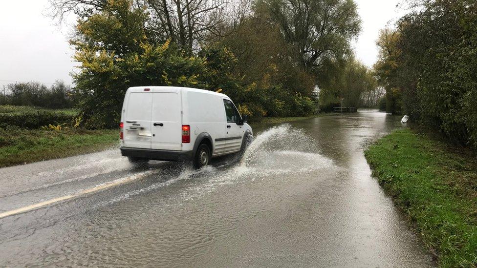 Van on flooded road