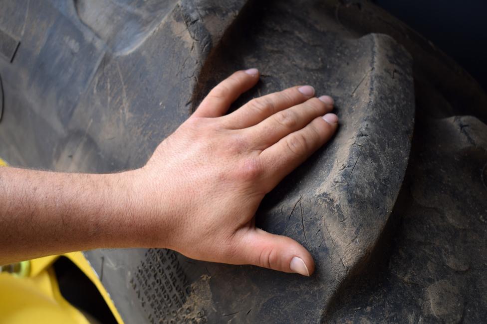 "Ivan's" hand on tractor wheel