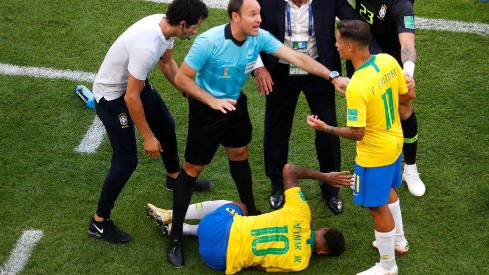 Neymar lies on the pitch during a World Cup match against Mexico.