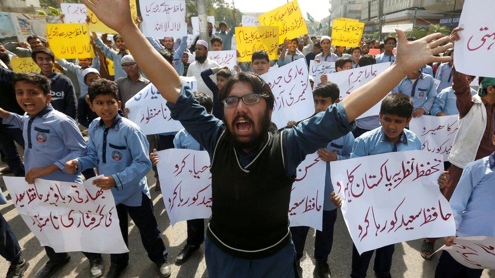 Student supporters of Islamic charity organization Jamaat-ud-Dawa (JuD), carry signs and chant slogans to condemn the house arrest of Hafiz Muhammad Saeed, chief of (JuD), during a protest demonstration in Karachi, Pakistan, 31 January 2017