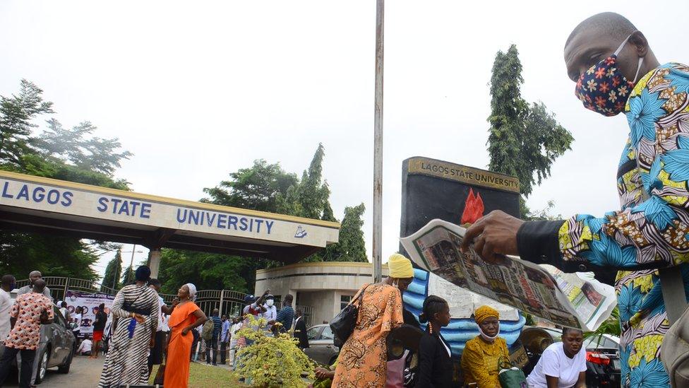 Students outside the gate of University of Lagos