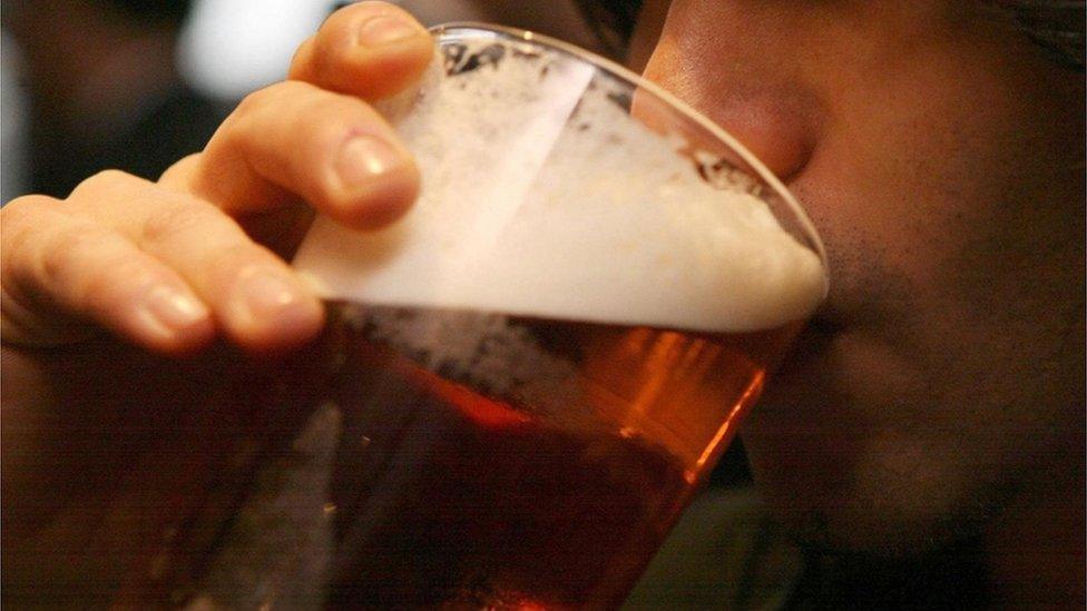 Man drinking beer - stock image