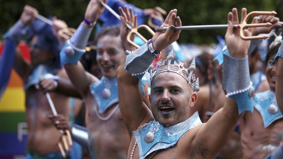 Participants in silver crowns and carrying tidents prepare for the annual Gay and Lesbian Mardi Gras parade in Sydney, Saturday, March 4, 2017.