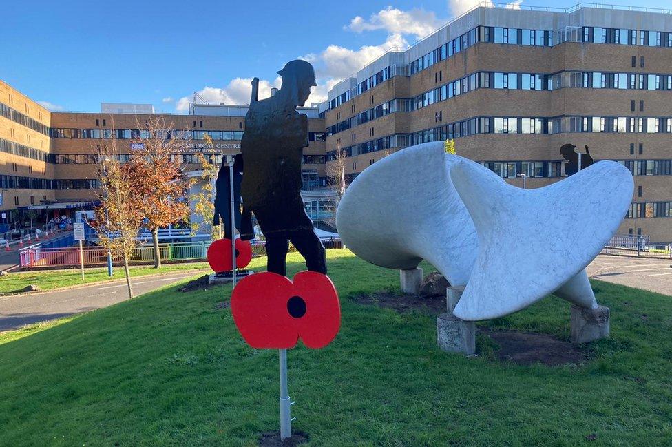 Silhouette of a soldier and poppy outside Queen's Medical Centre