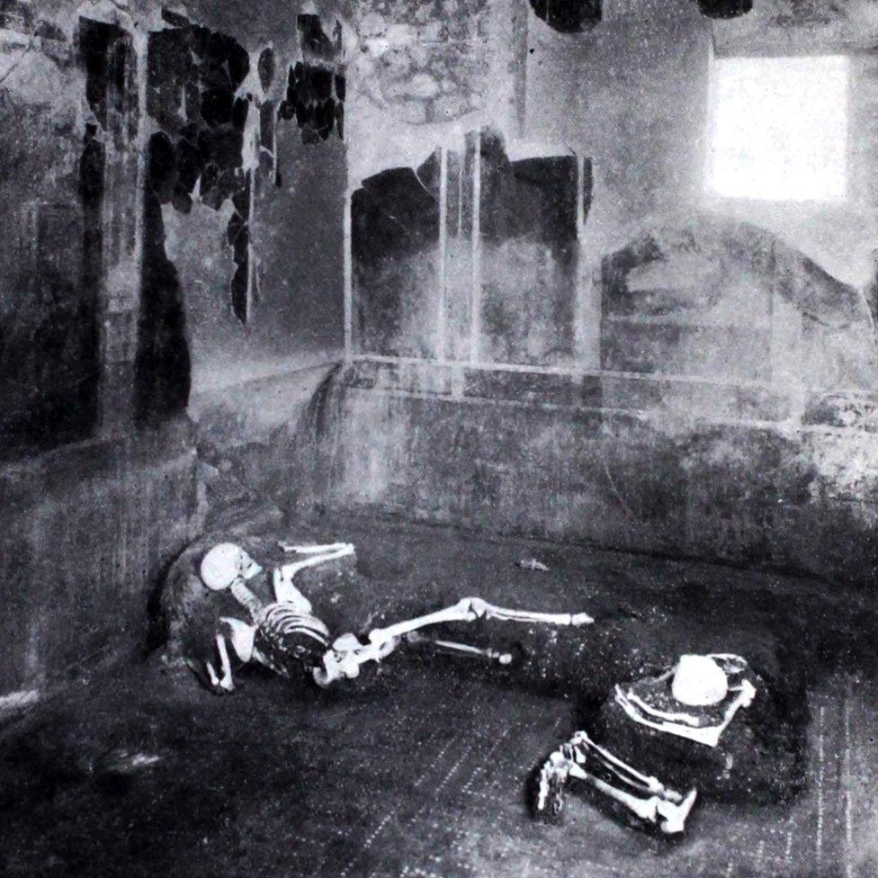 Remains of two individuals found in the Casa del Fabbro, or House of the Craftsman, in Pompeii, captured in a photograph taken in 1934