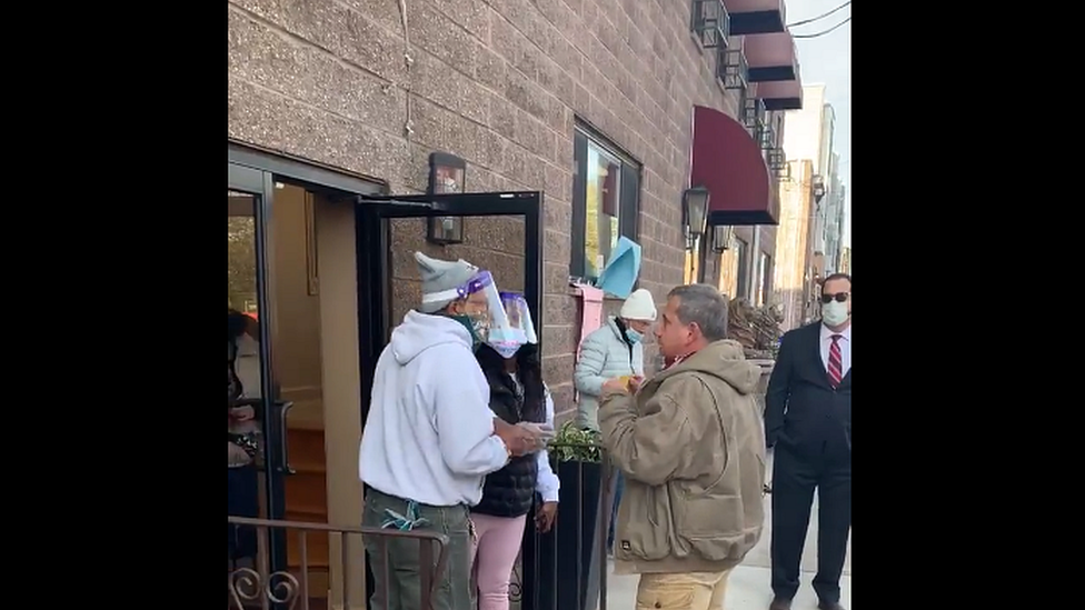 Man talking to election officials outside polling station