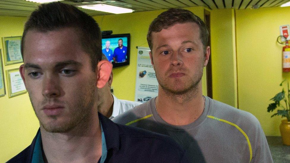 US Olympic swimmers Gunnar Bentz, left, and Jack Conger, right, leave the police station at Rio airport on 18 August 2016