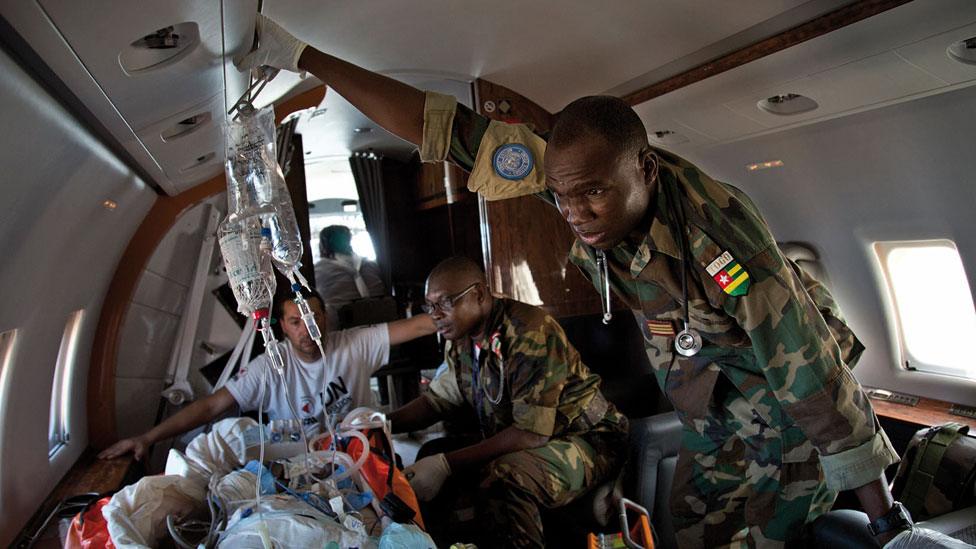 Peacekeepers attending to a wounded person in Mali