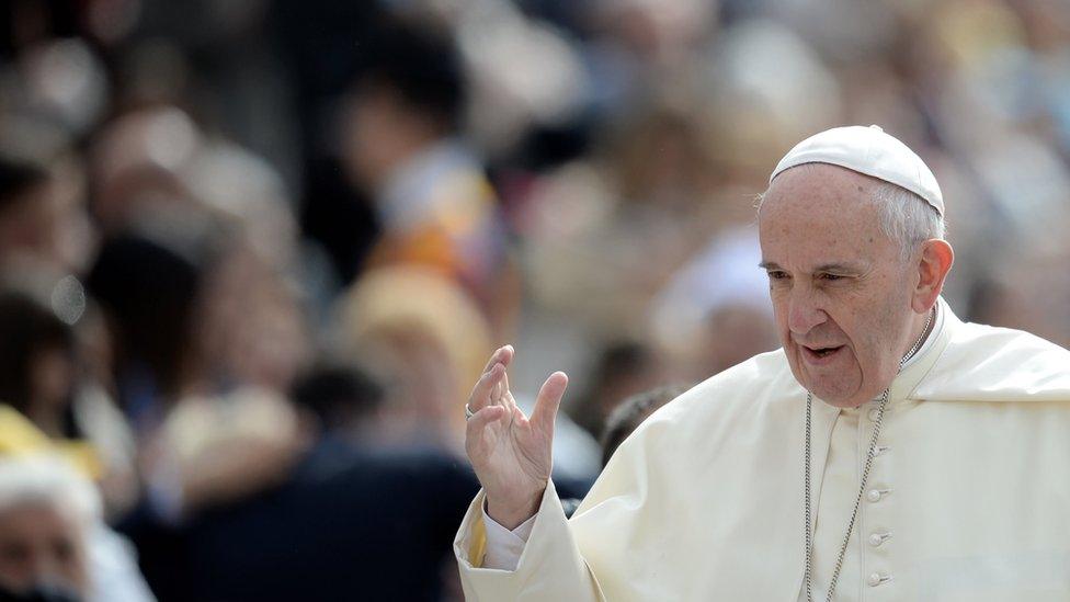 Pope Francis waves to the crowd of faithful gathered in St Peter Square at the Vatican