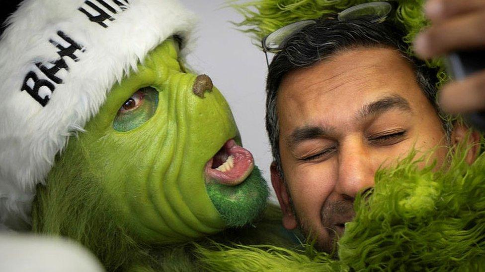 The Grinch hugging a doctor