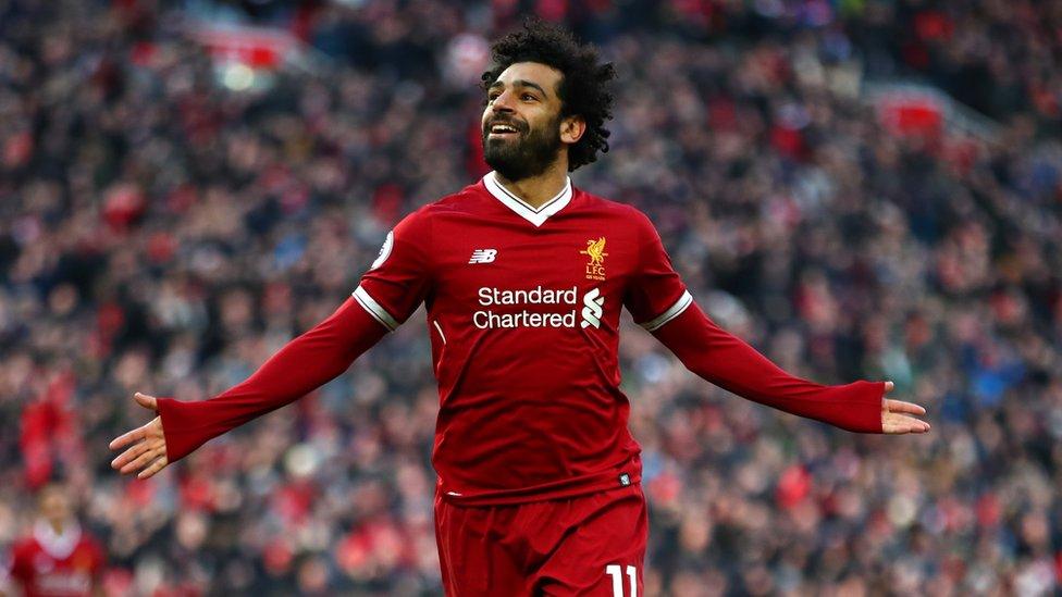 Mo Salah celebrates a goal with his arms out wide