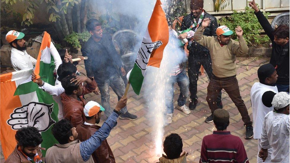 Congress-JMM alliance workers celebrate results projecting an assembly majority in the Jharkhand state election in Ranchi on December 23, 2019