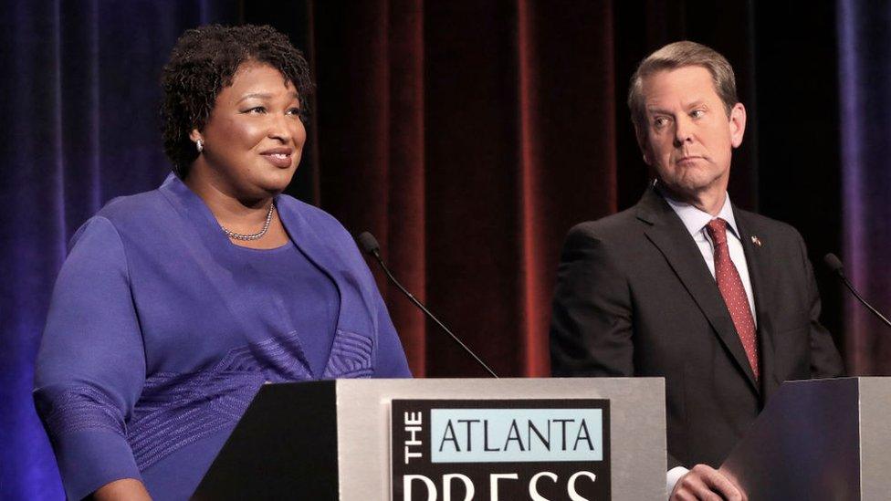 Stacey Abrams (left) and Brian Kemp (right) at a debate.