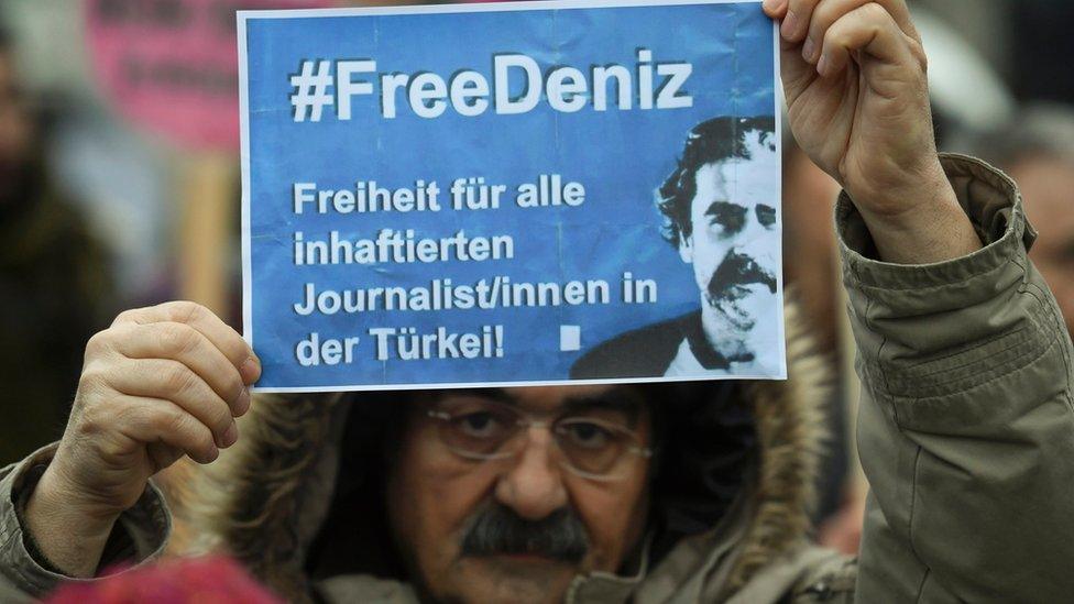 A protester demands release of journalist Daniz Yucel