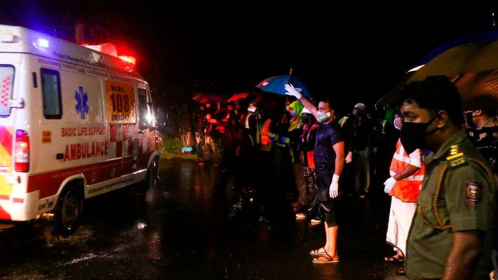 An ambulance carrying injured passengers leaves for a hospital.