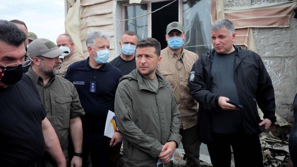 President Volodymyr Zelensky (centre) visiting Luhansk on Tuesday after wildfires ravaged the area