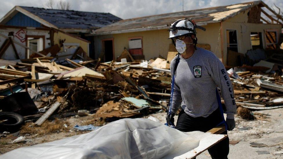 A body is removed from the Mudd shanty town on Great Abaco