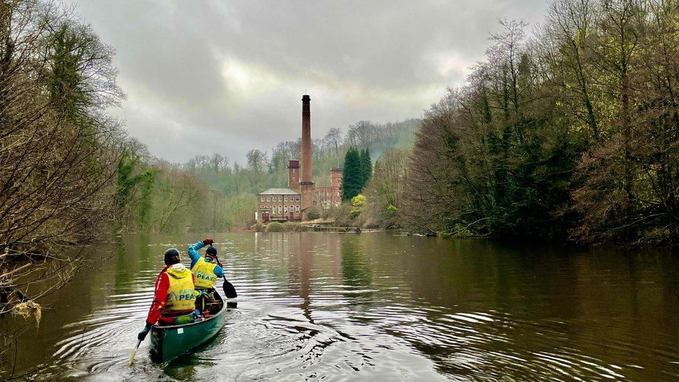 Peak paddle kayakers cleaning up the river banks