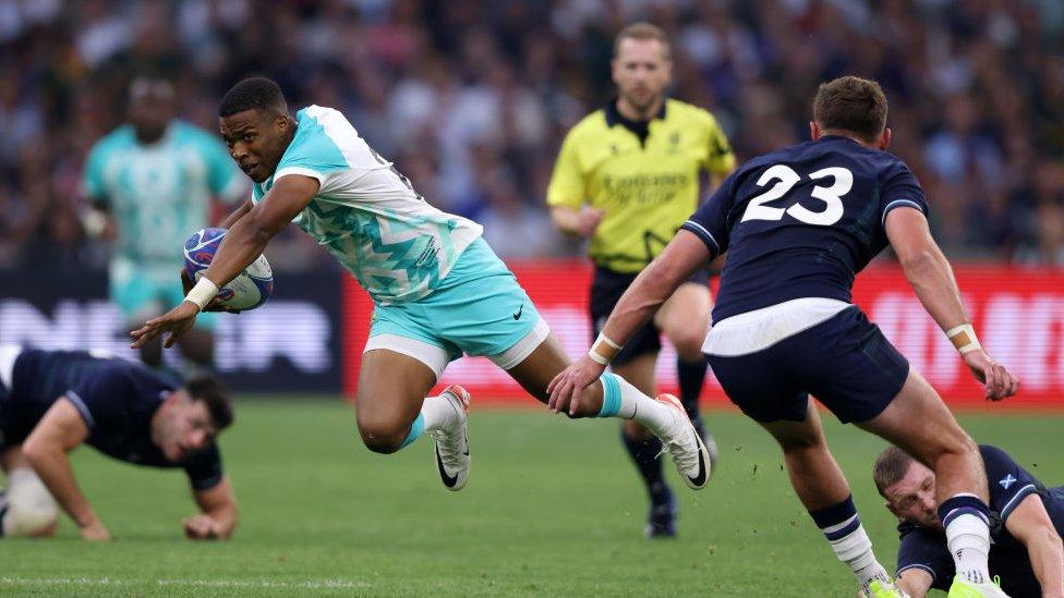 South Africa's Grant Williams being tap tackled by Scotland's Finn Russell