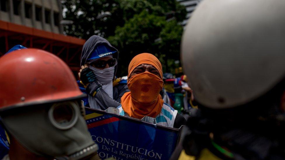 Protesters with a mock-up of the Venezuela constitution