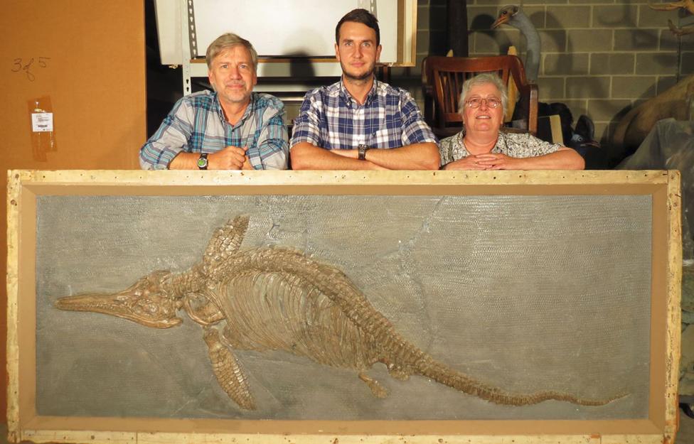 Palaeontologists with one of the fossils