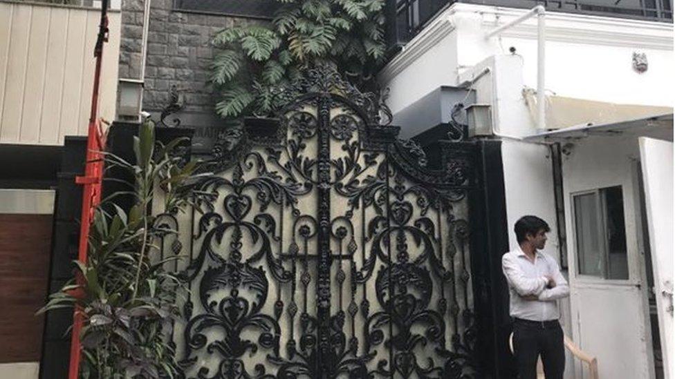 An ornate gate in front of a building