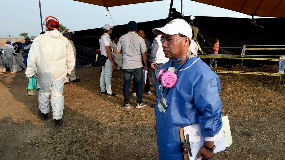 Forensic medical personnel prepare to exhume 116 bodies found in a mass grave at Tetelcingo community in Morelos State, Mexico on May 23, 2016